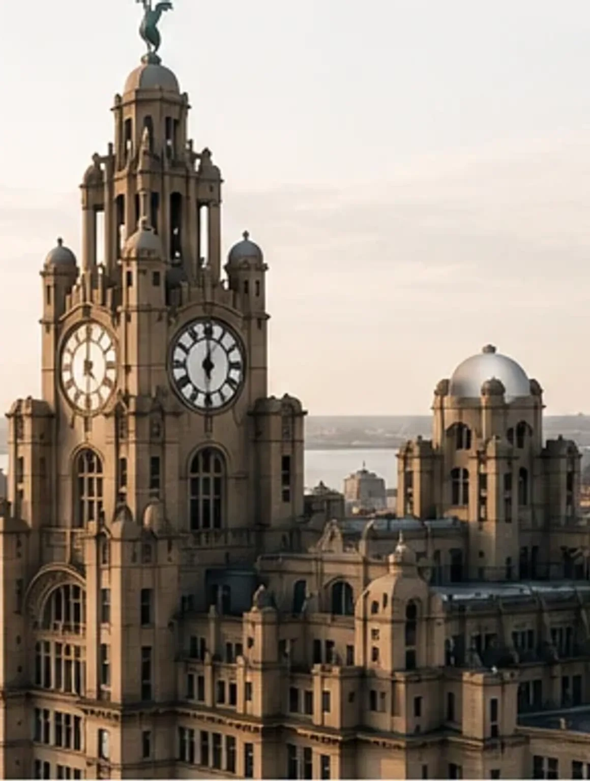 The Royal Liver Building's clock towers rising above the Liverpool waterfront in golden light