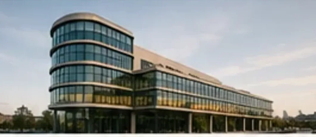 Modern curved glass healthcare building in evening light